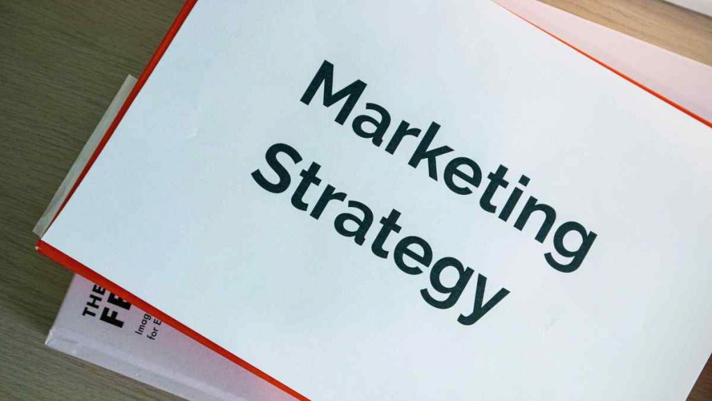 Marketing strategy document on desk, representing the role of a digital marketing strategist