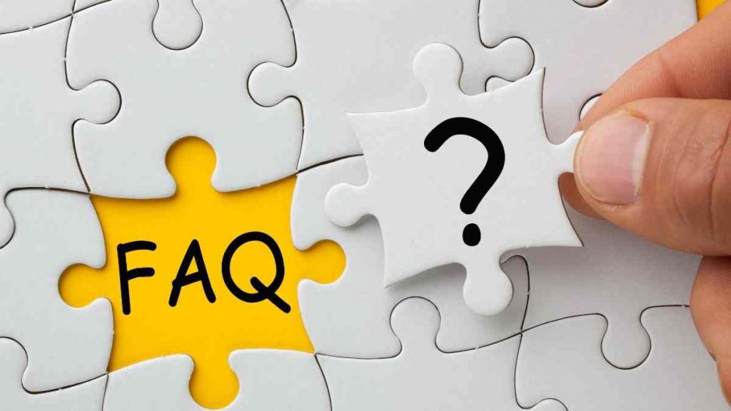 Close-up of a white puzzle with one missing piece, showing the letters FAQ on a yellow background.