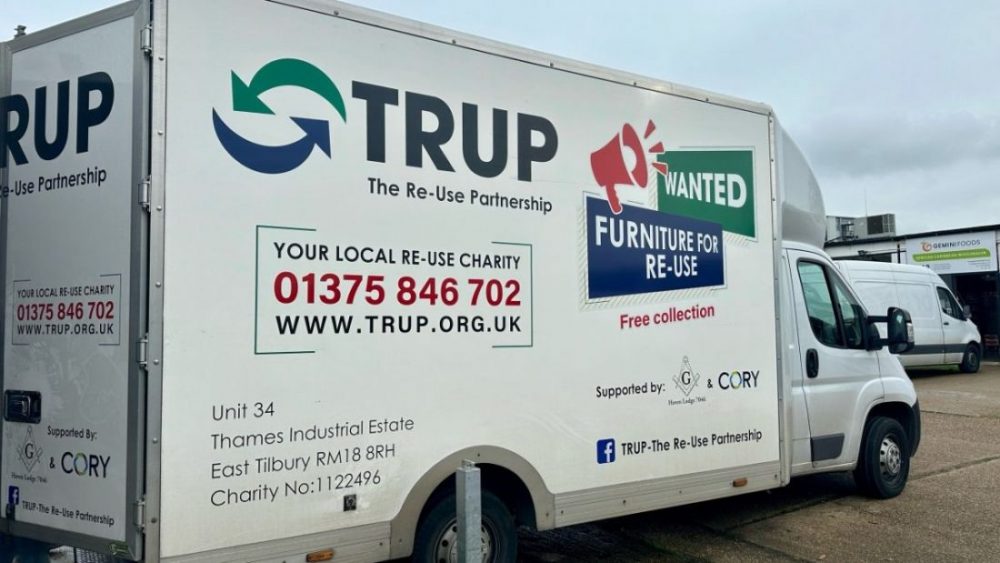 A TRUP charity van with signs asking for furniture donations for re-use and offering free collection.