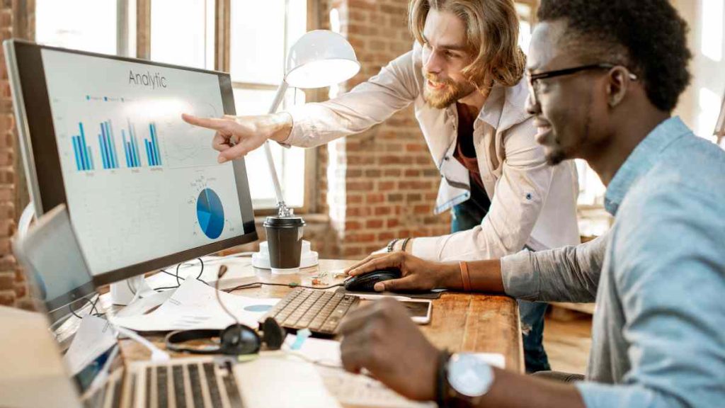Team reviewing campaign performance charts and analytics data with the support of an email marketing agency.