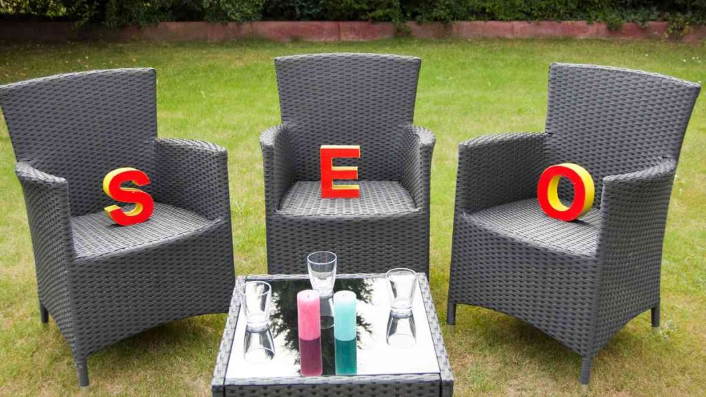 Three chairs outdoors with large letters S, E, and O placed on them, representing the elements of SEO in digital marketing.