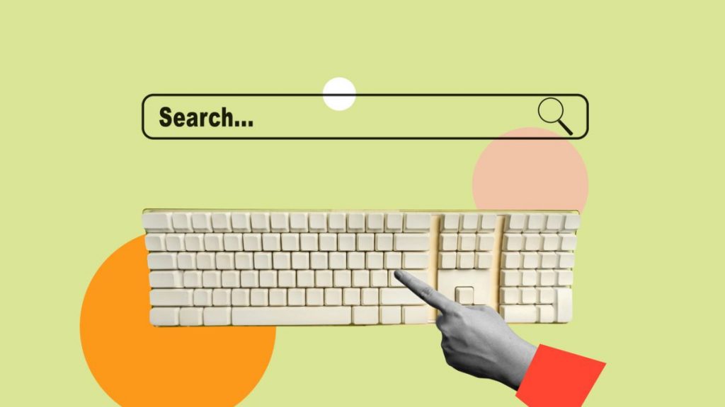 Creative flat lay of a keyboard and search bar on a colourful background, symbolising online search