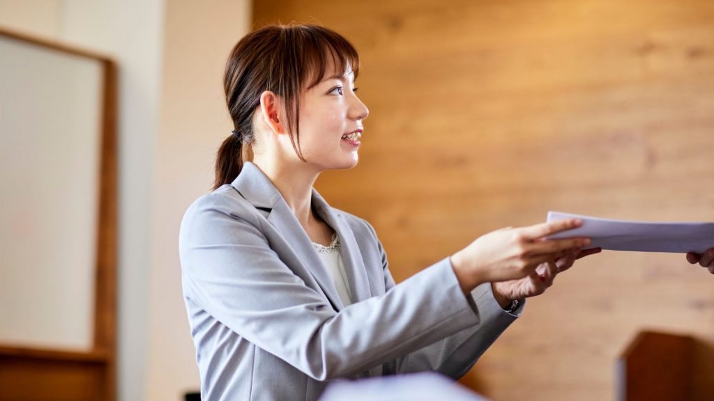 Businesswoman sharing documents as part of a marketing partnership