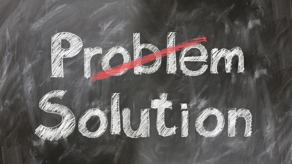 Finding solutions to problems with digital marketing agencies — the word “Problem” crossed out and replaced with “Solution” on a chalkboard.